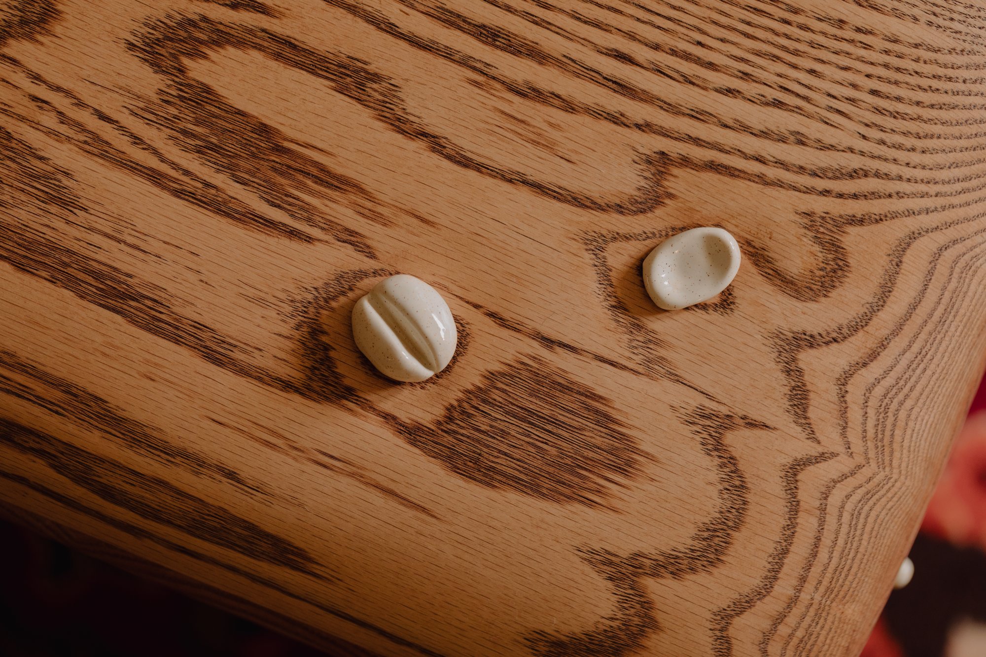 Ceramic charms set into carved oak, detail of a Studio Backcountry piece