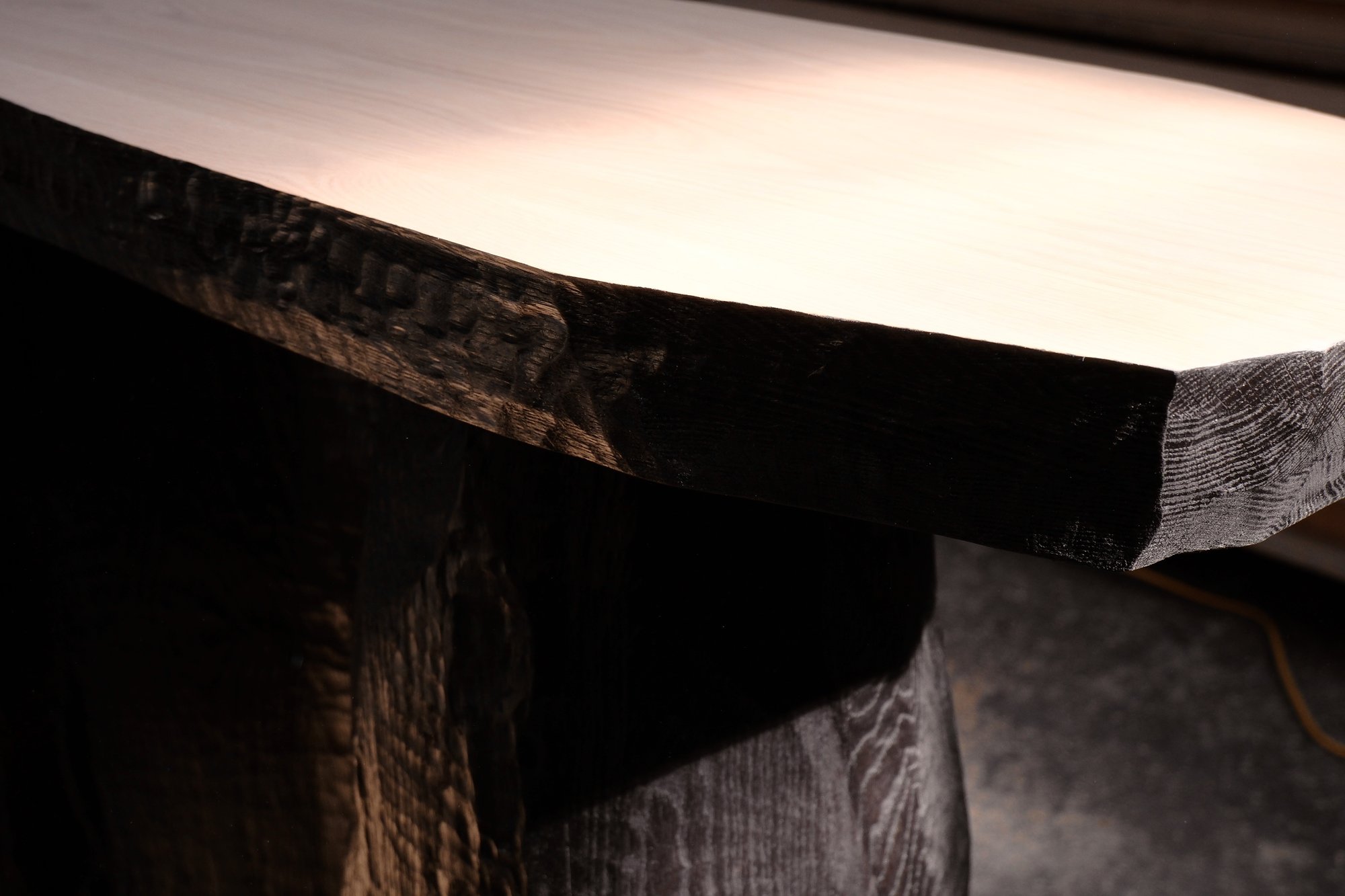 Relief Console carved edge detail, pale oak top over a blackened base